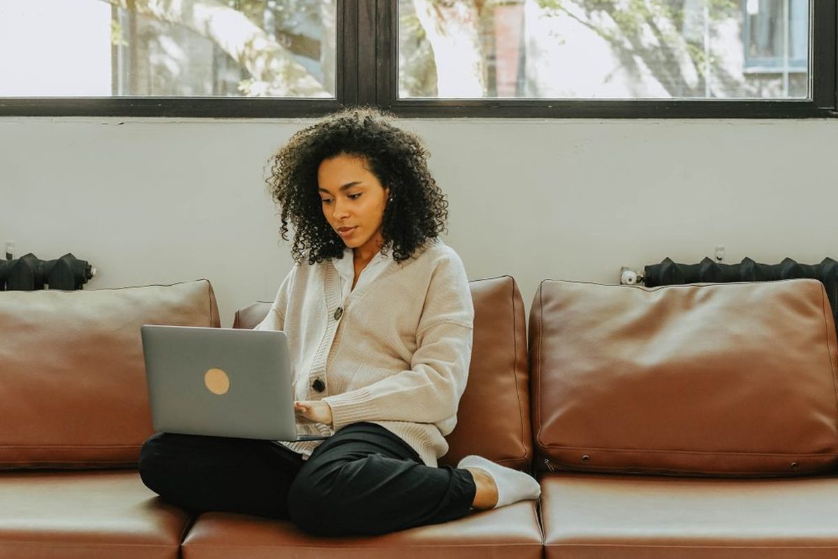 Smiling woman planning her monthly budget at home